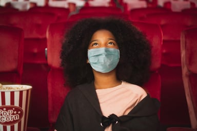kid in mask at movie theater