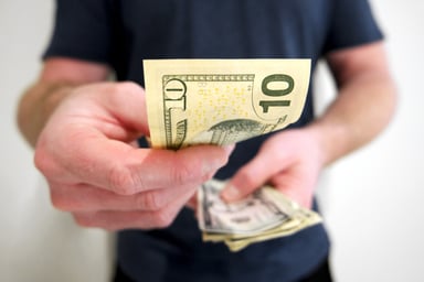 man offering a $10 bill