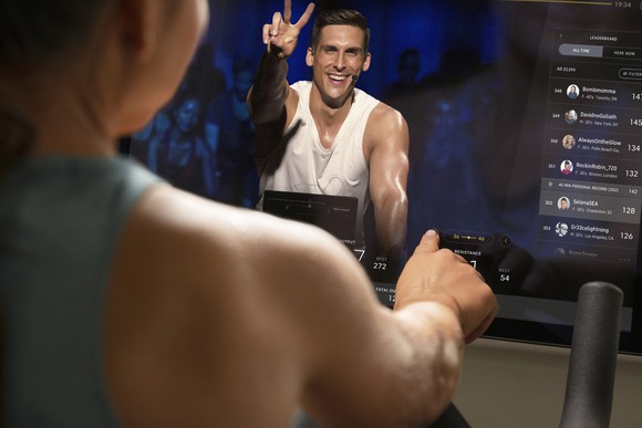 A Peloton user taking an exercise class.