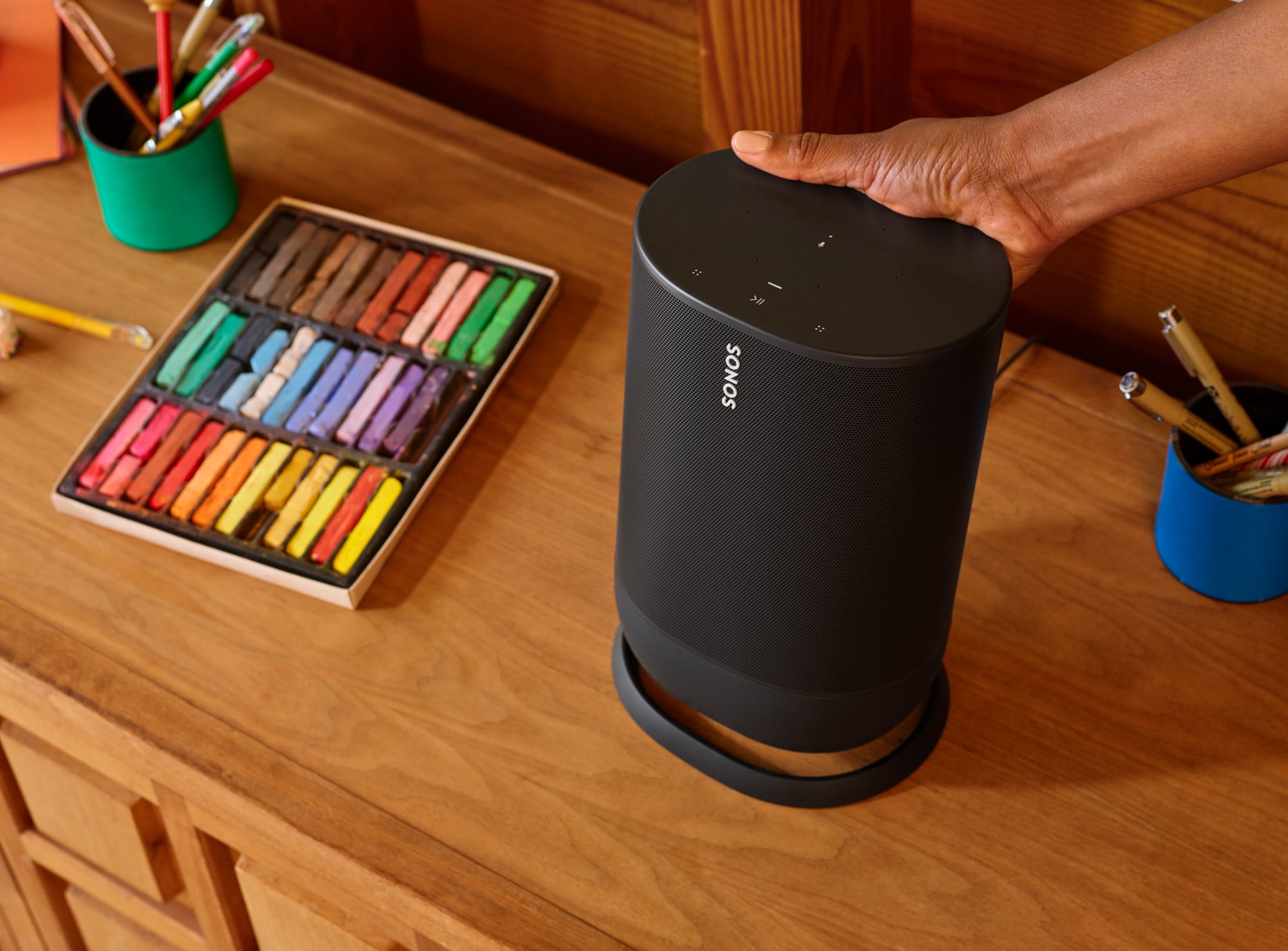 Hand lifting a Sonos Move speaker