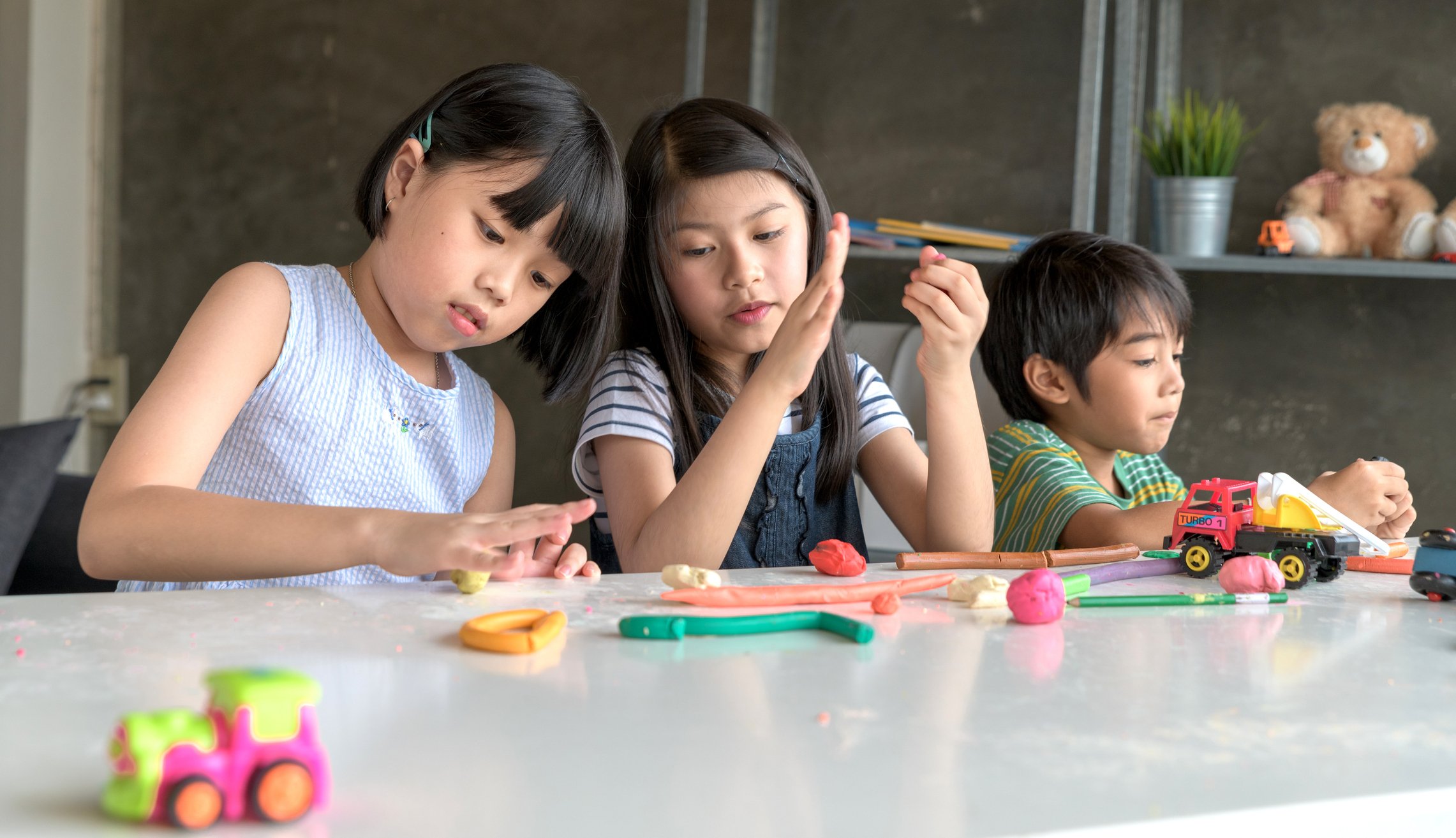 children playing with clay toys
