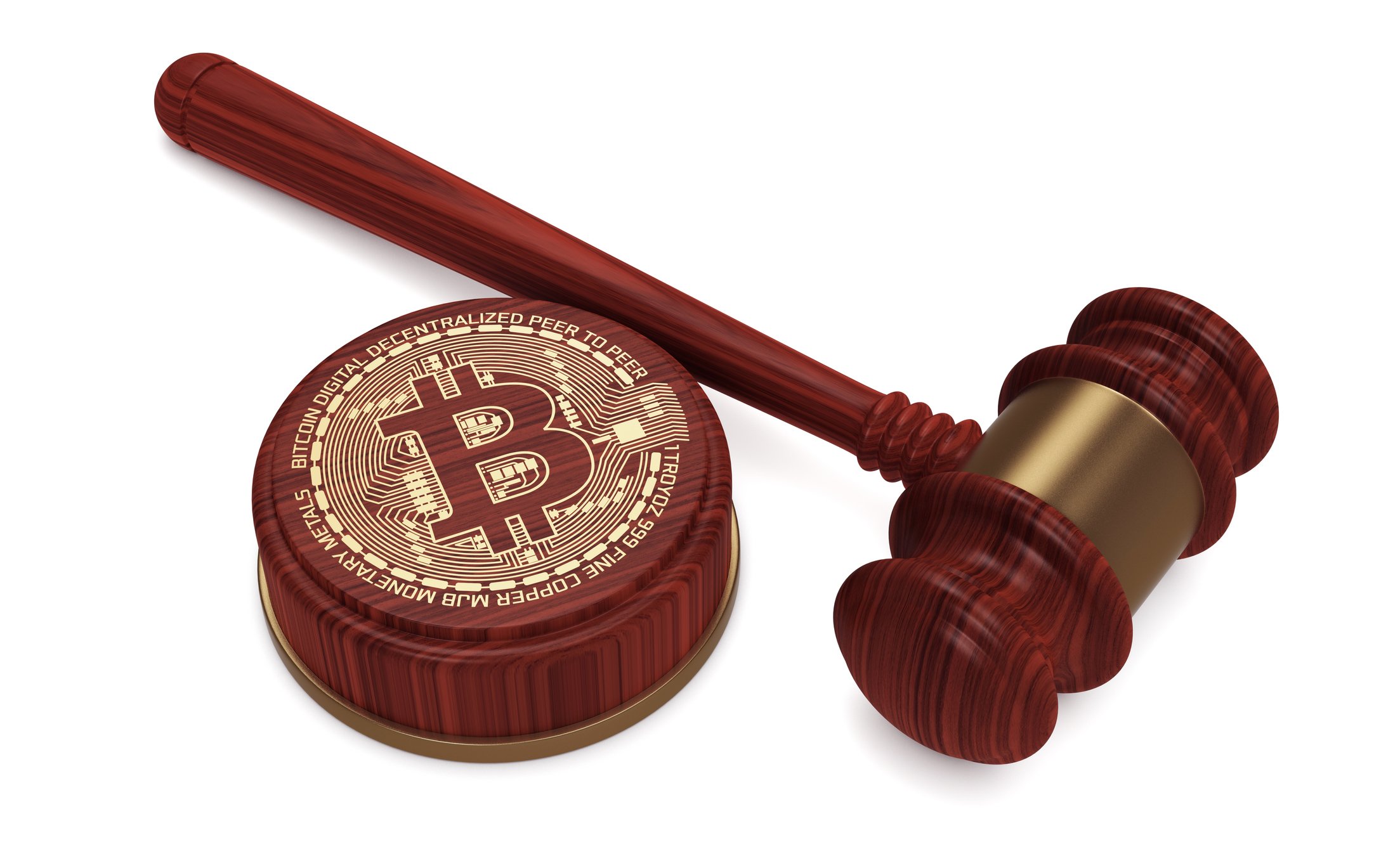 A judge's gavel resting next to a wooden stand decorated with the bitcoin logo.