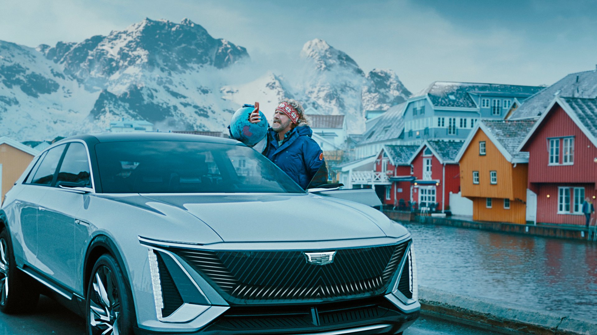 The actor Will Ferrell, with a Cadillac Lyriq in a Norwegian town. 