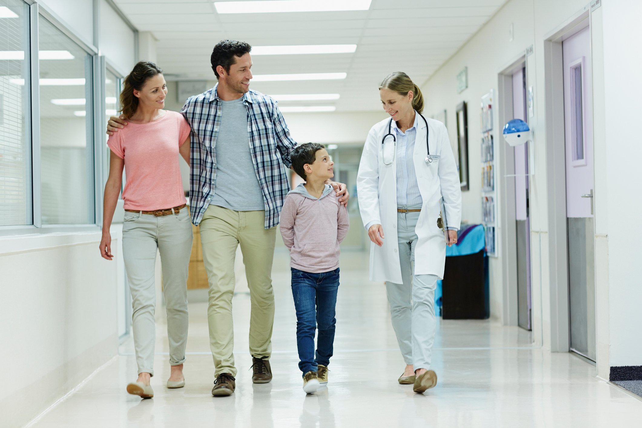 Happy family walking through a hospital.