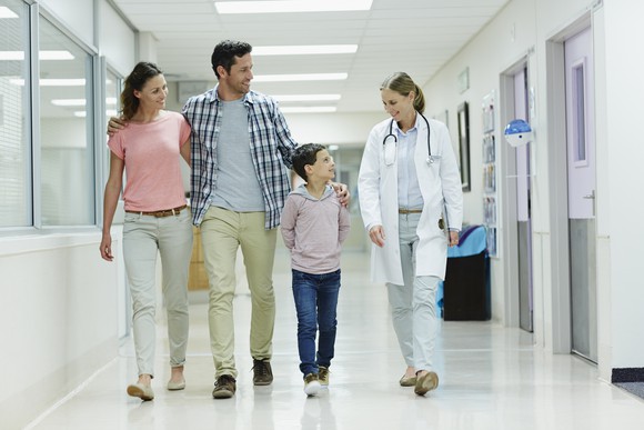 Happy family walking through a hospital.