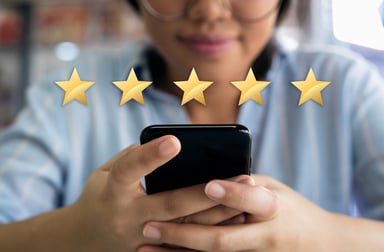 Woman using smartphone 5 gold stars