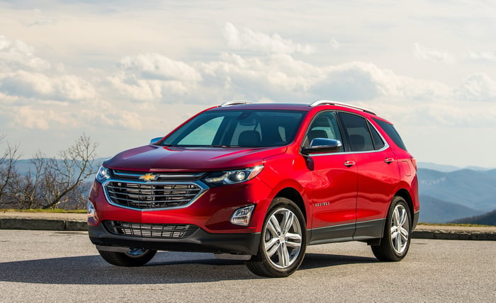 A red Chevrolet Equinox, a compact crossover SUV. 