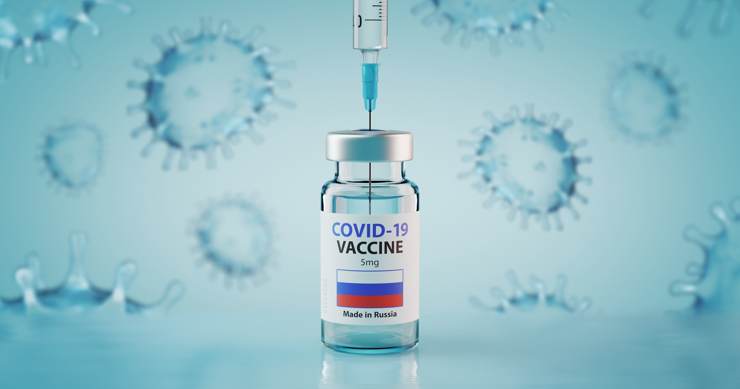 A hypodermic needle inserted into a vial labeled Covid-19 Vaccine, above a Russian flag and the words Made in Russia
