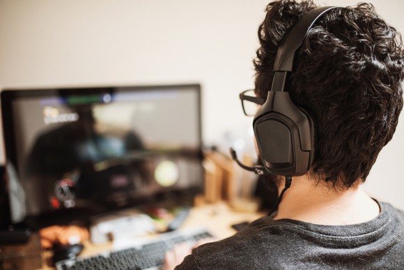 Man playing games and wearing a headset