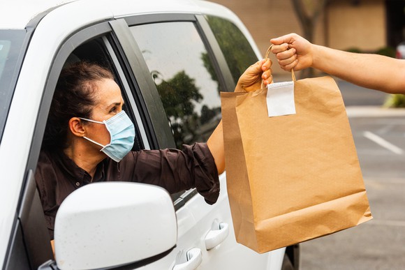 A driver handing a delivery to a customer.