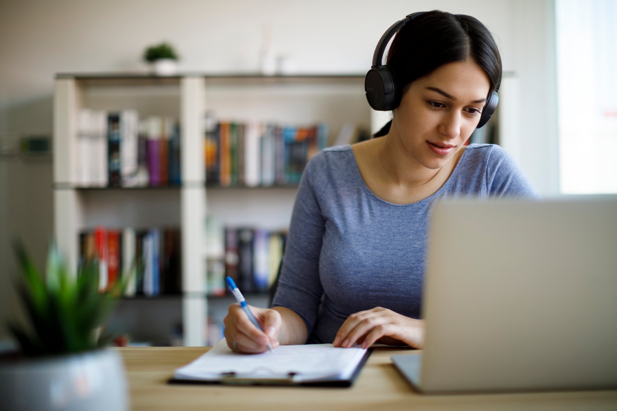 A young woman takes an online course on her laptop.