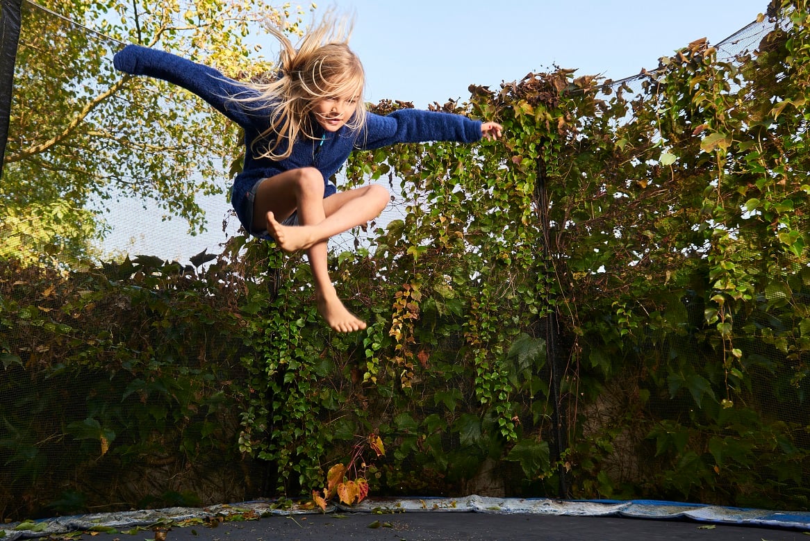 Child bouncing on a trampoline.