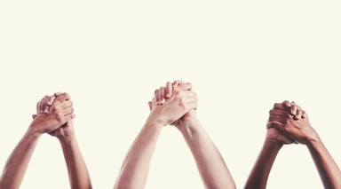 3 pairs of hands clasped together