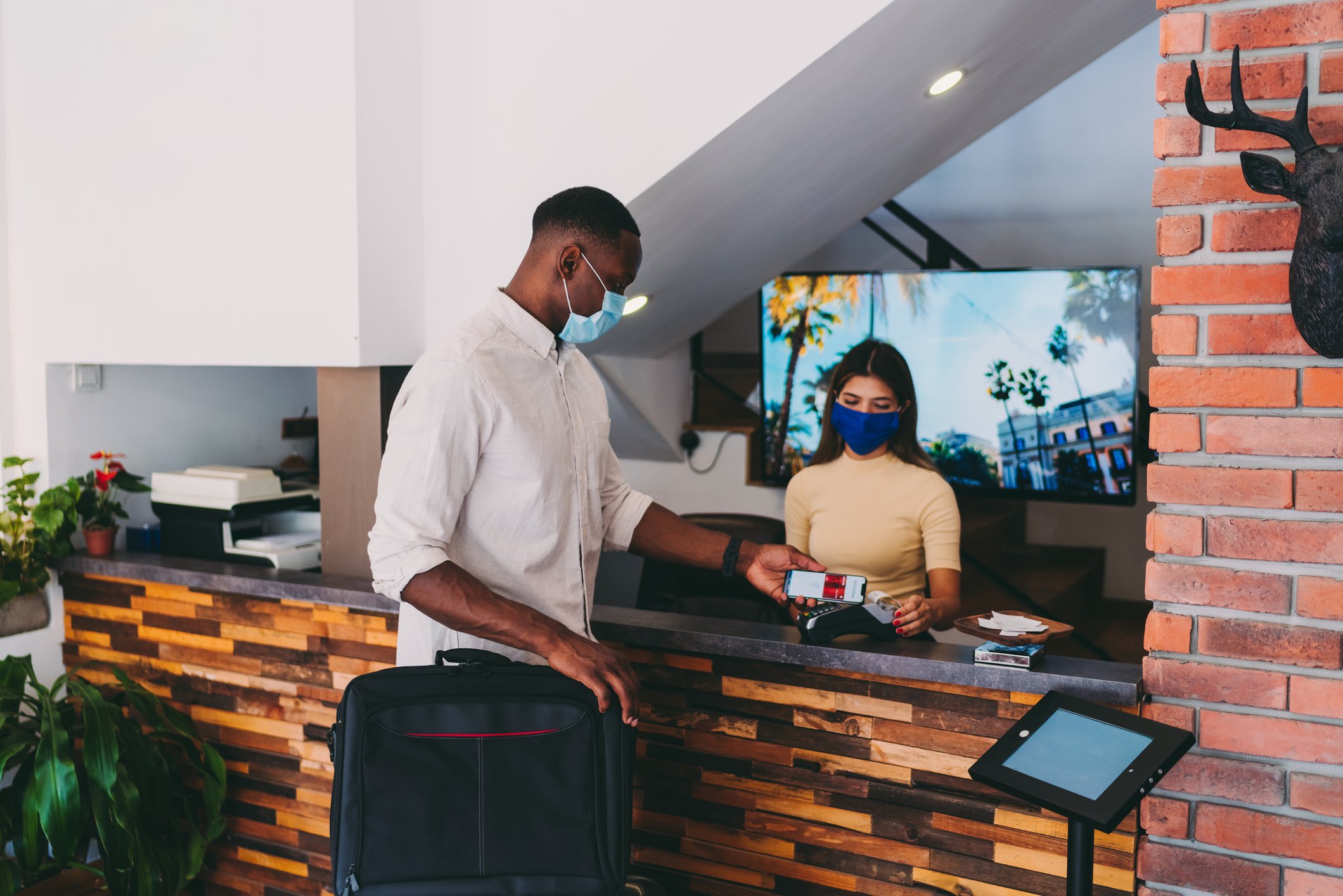 A person paying at a hotel.