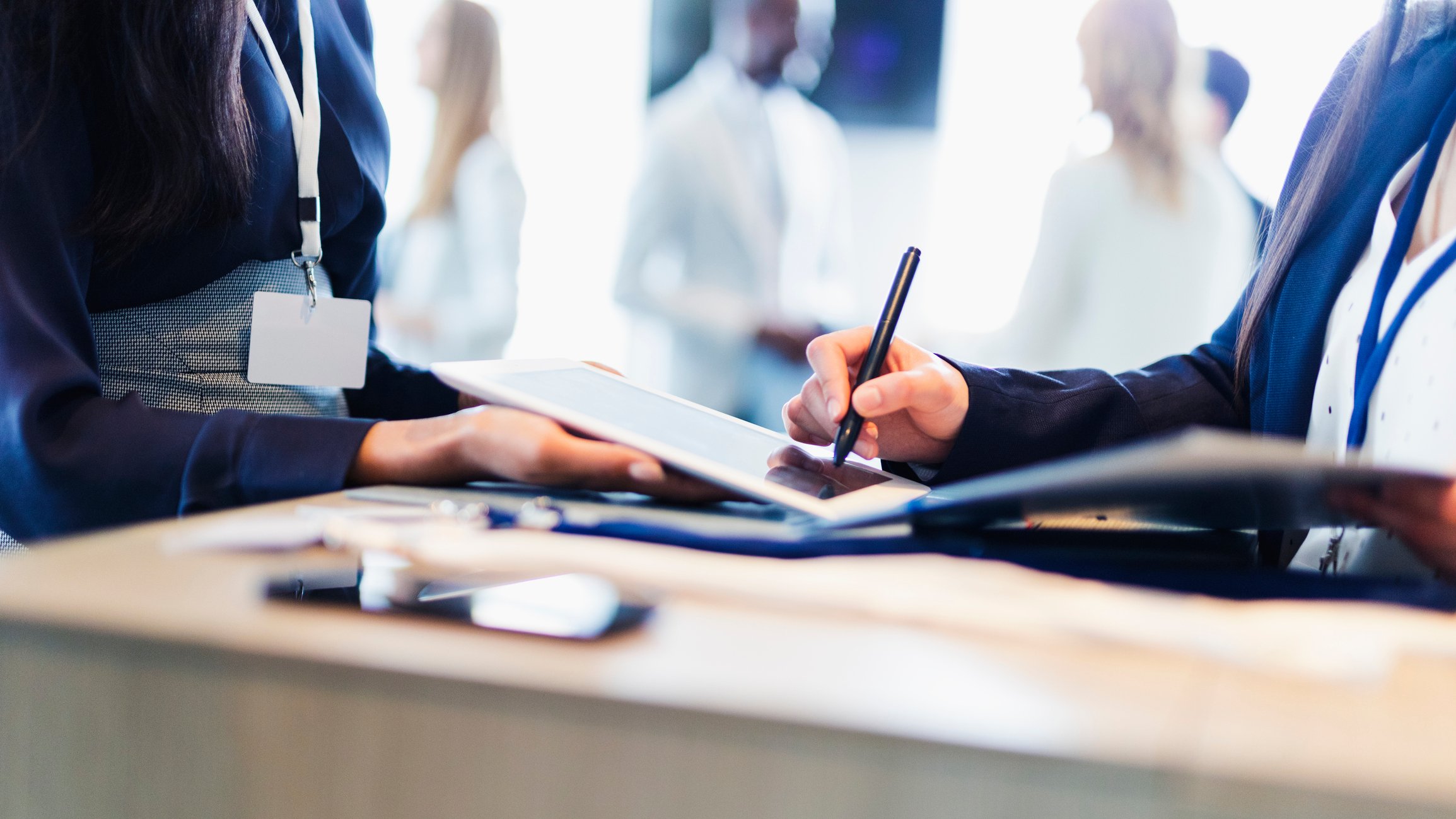 Person using right hand to sign on a tablet computer