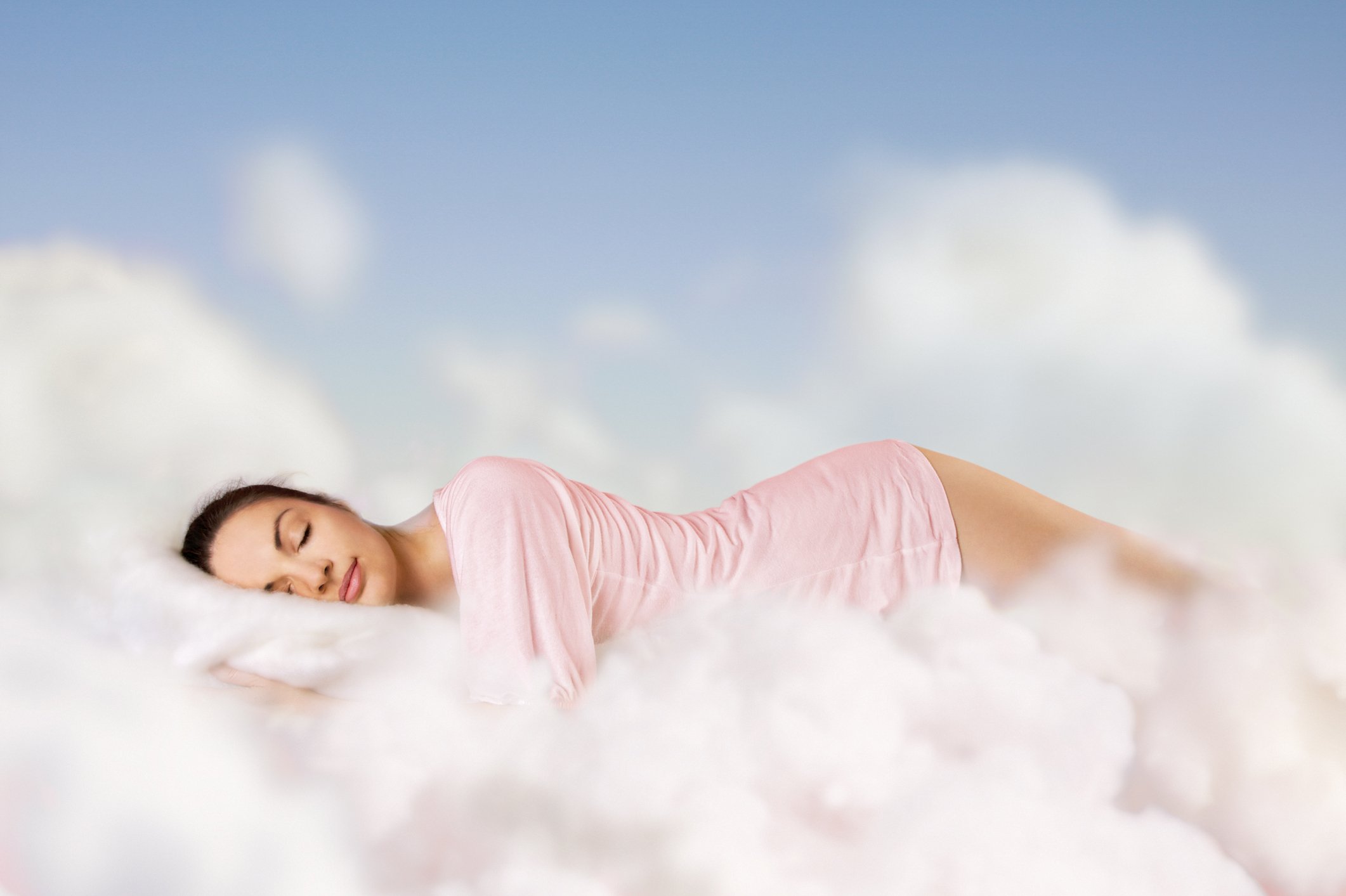 Woman sleeping in clouds