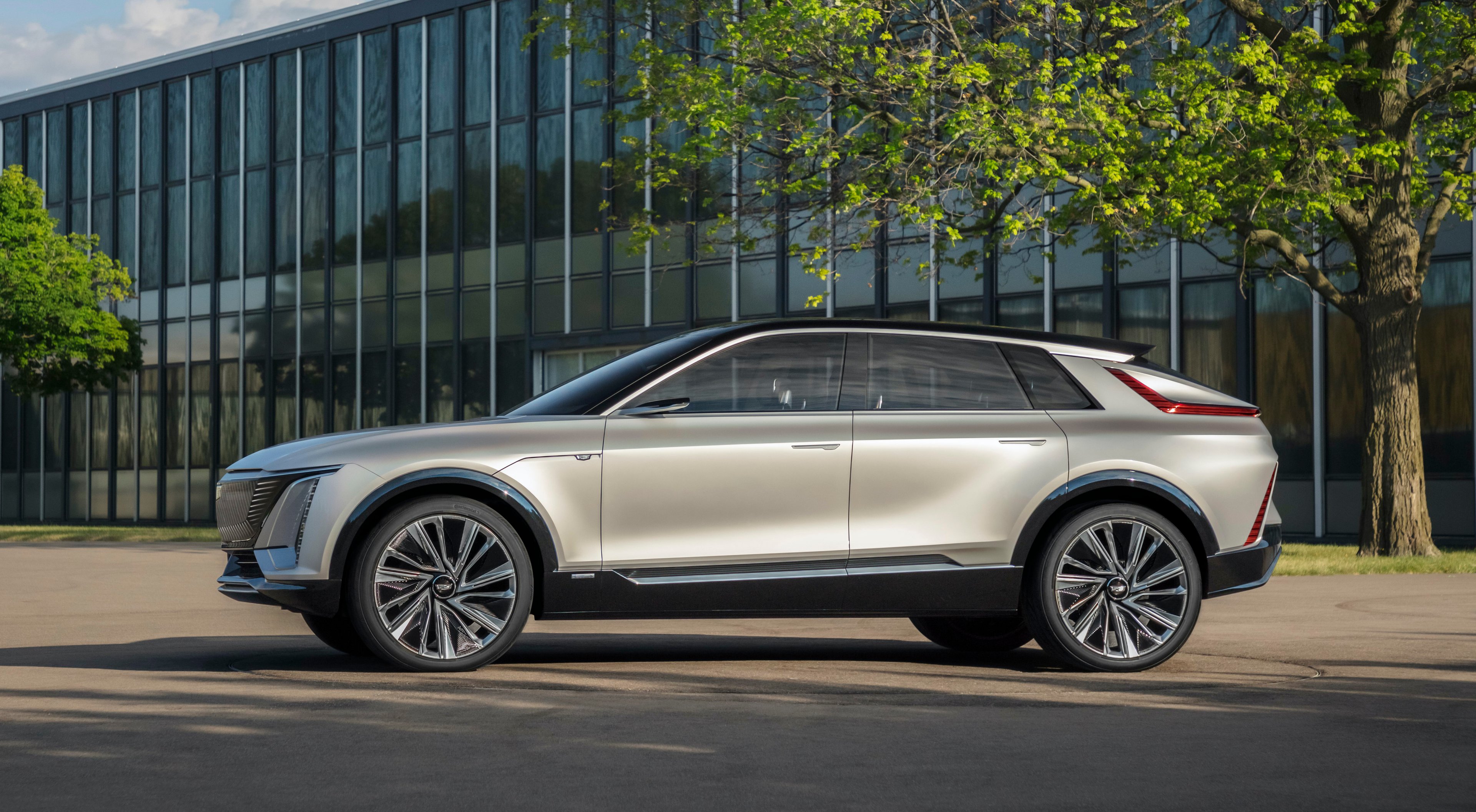 A silver Cadillac Lyriq, a sharply-styled electric luxury SUV. 