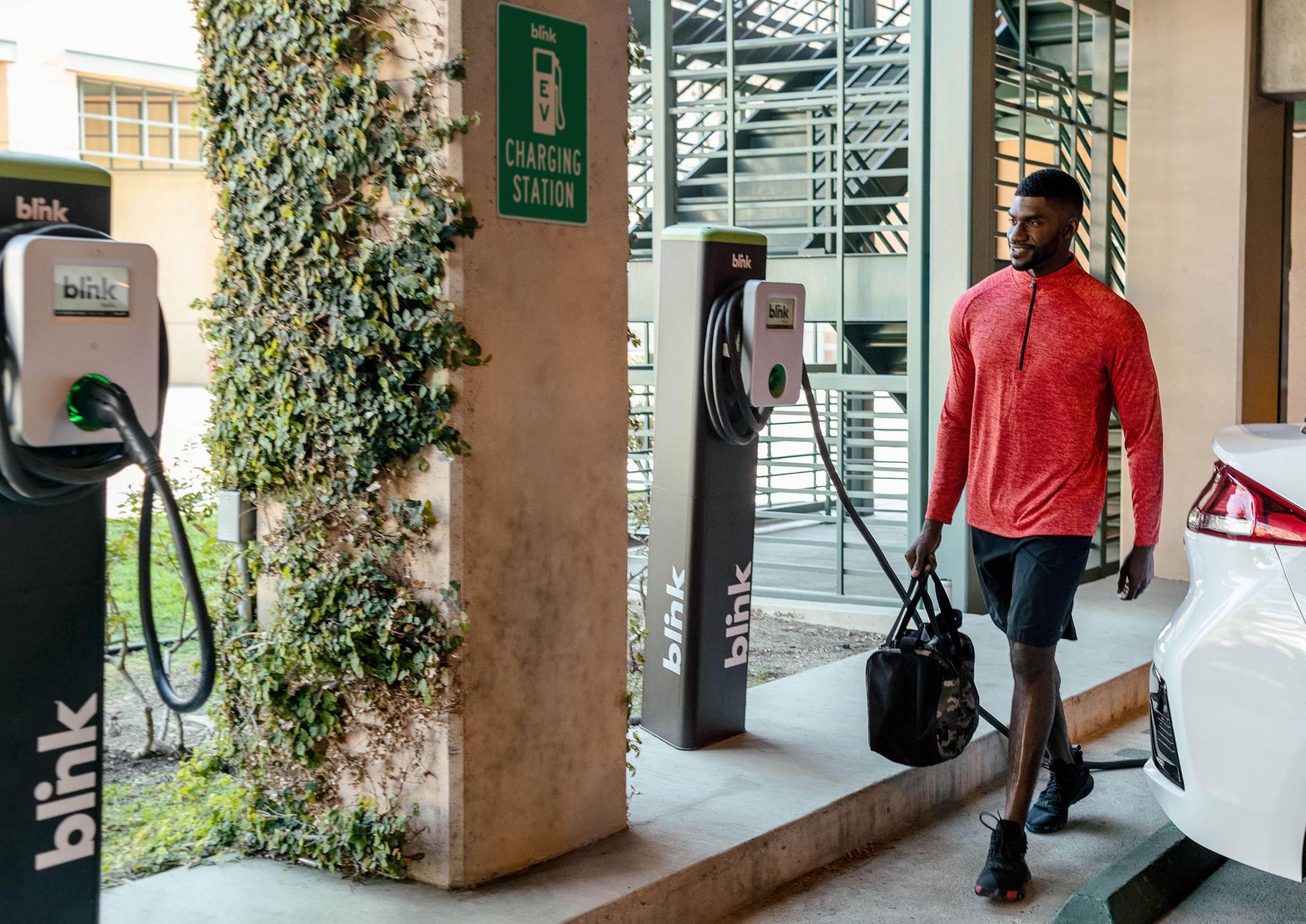 Man walking by Blink chargers 