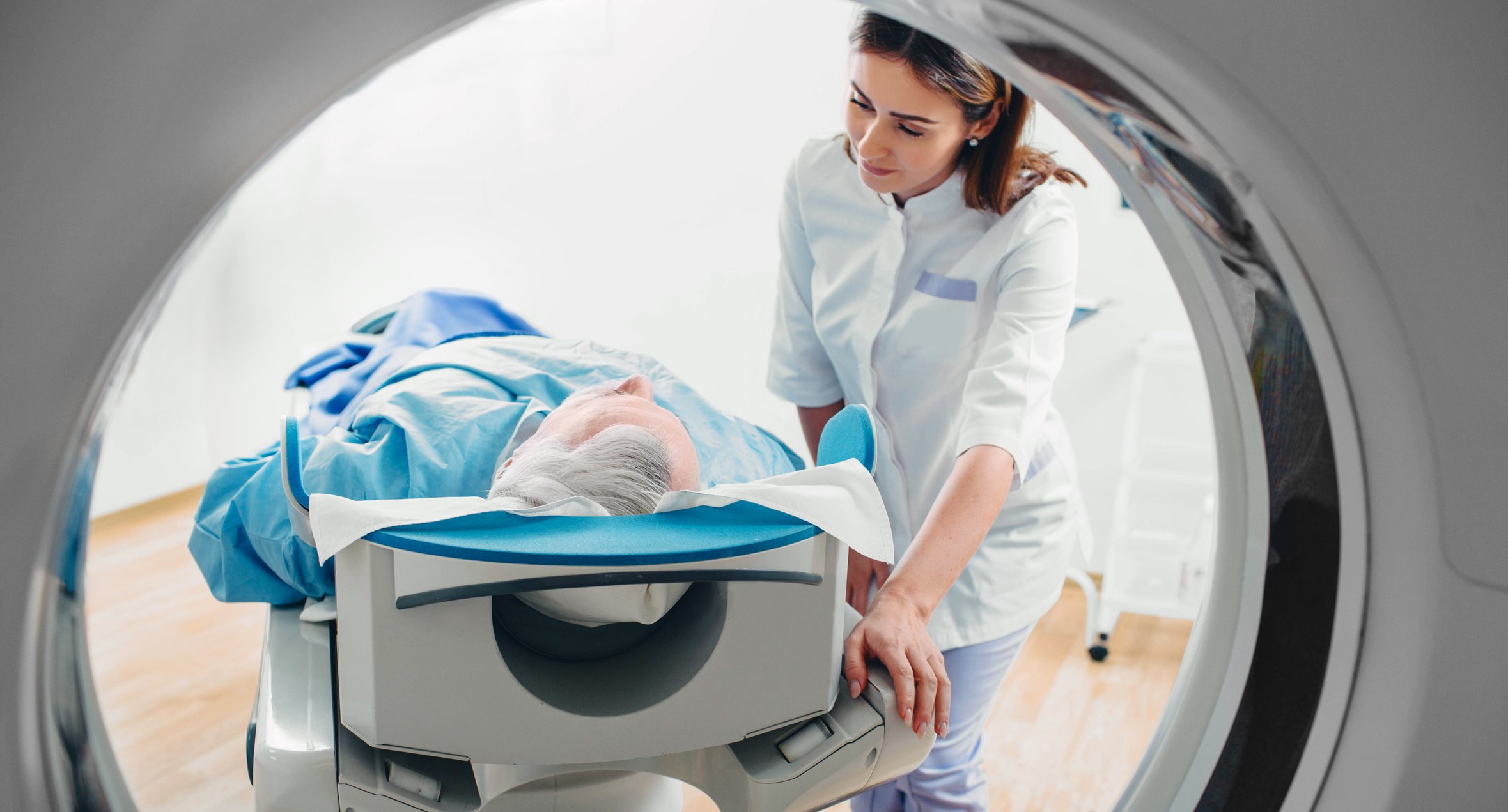 A man entering a CT scanner.