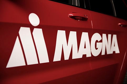 The Magna logo on a red vehicle's door. 