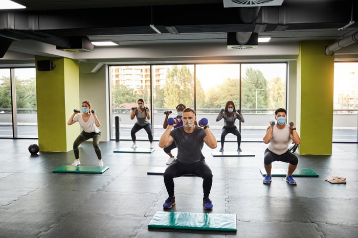 indoor fitness class doing squats