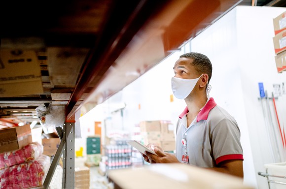 A worker in a bulk shopping warehouse.