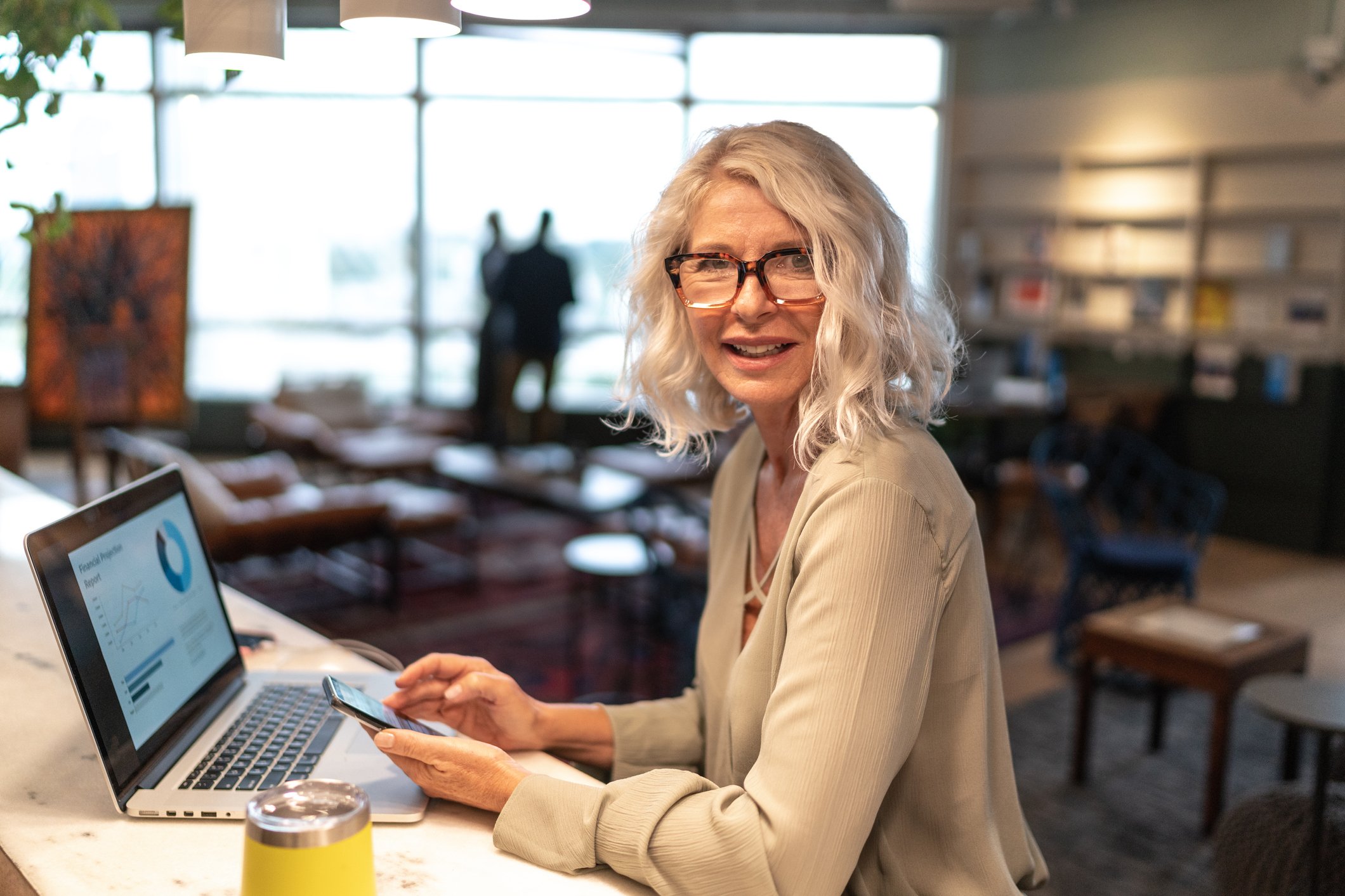 Woman sitting in front of a computer analyzing her investments.
