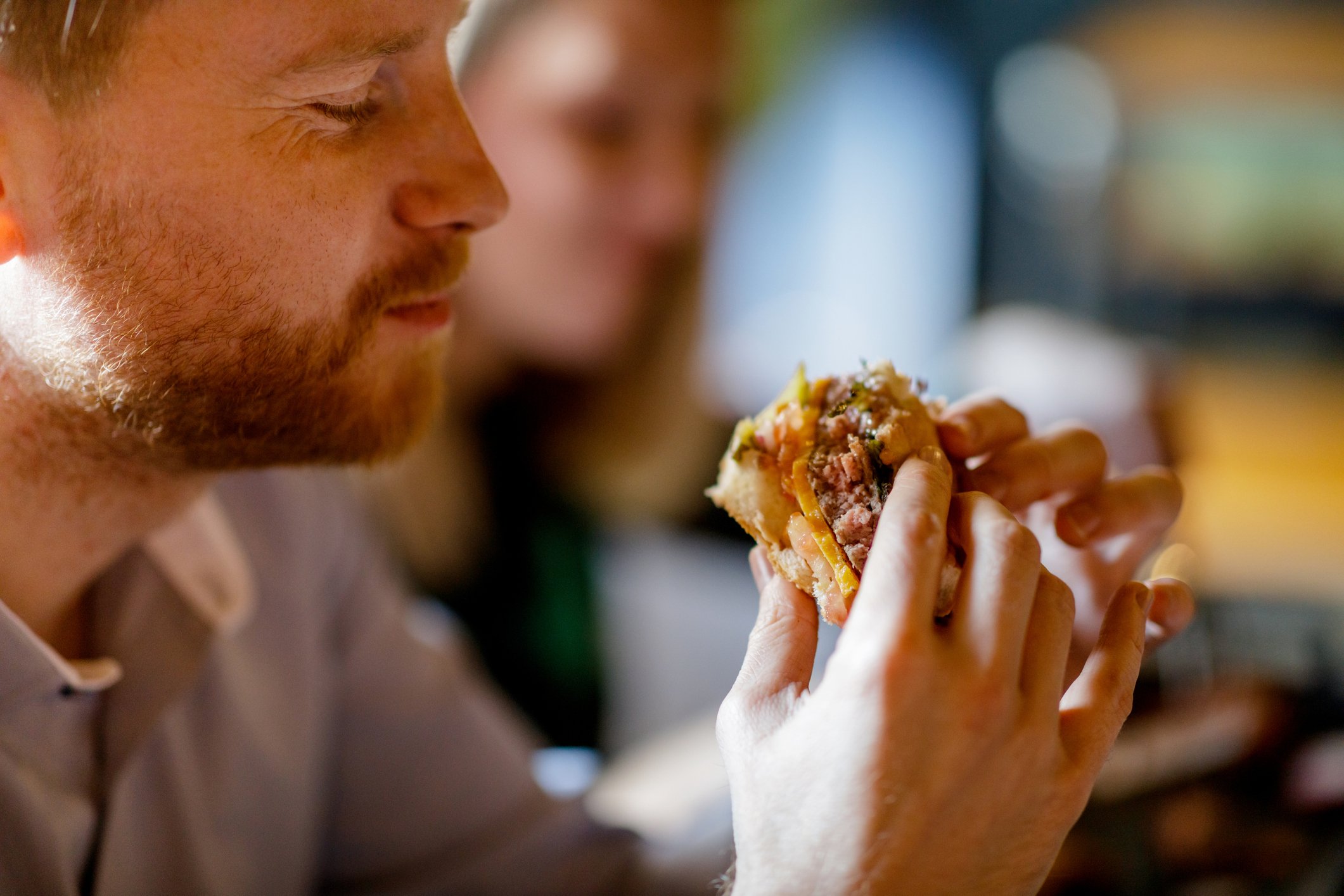 A man eating a burger.