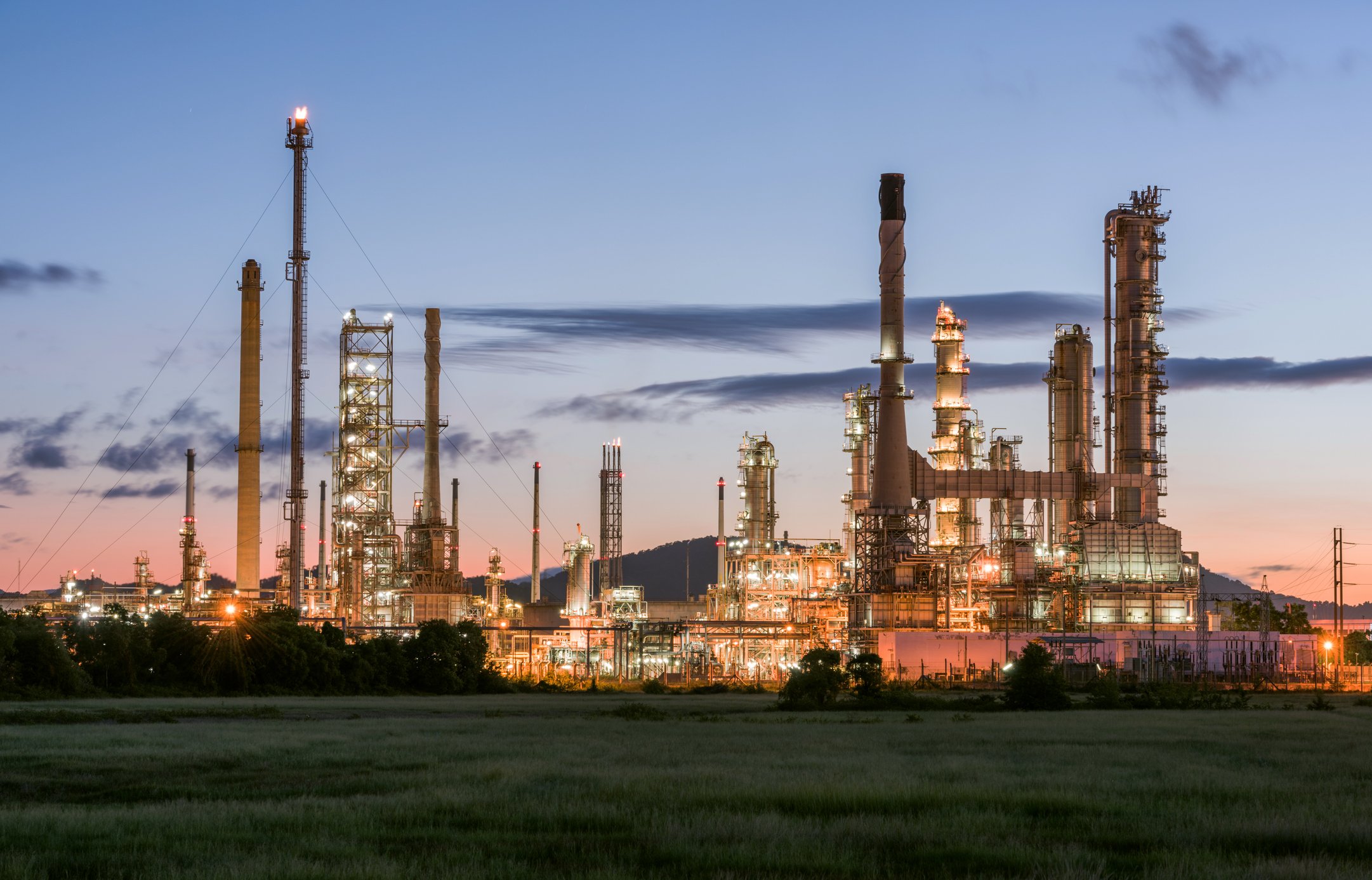 Oil refinery with lights in evening.