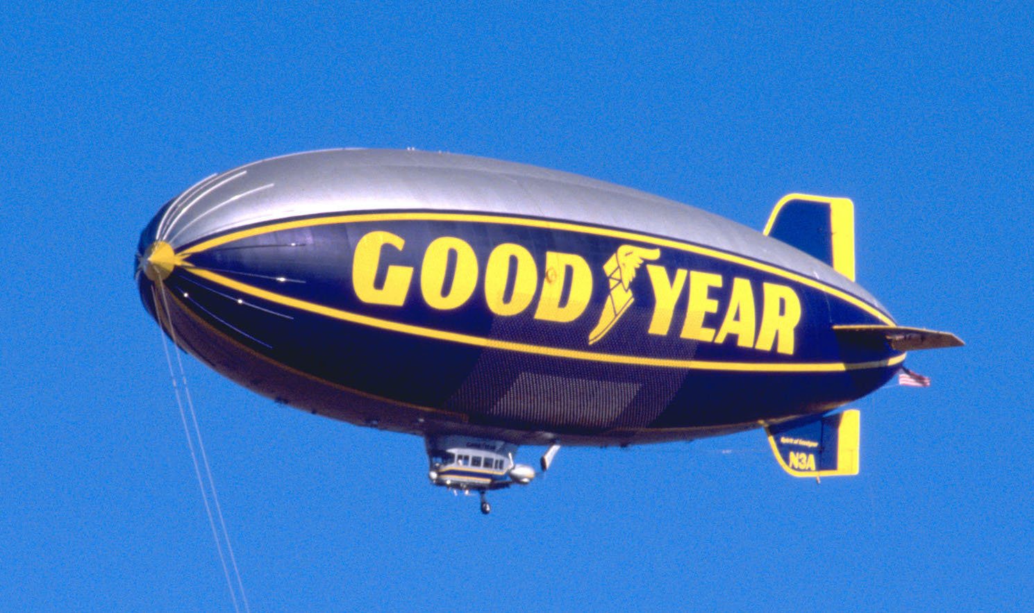A Goodyear blimp aloft on a clear day. 