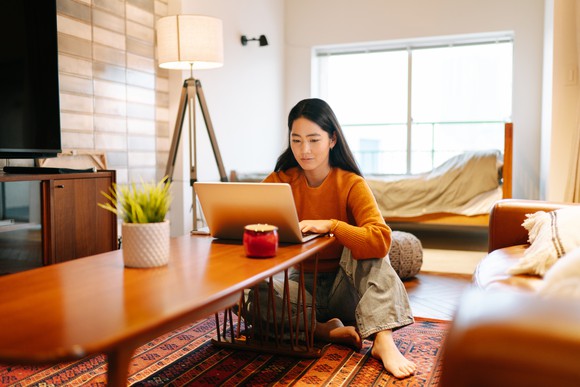 A woman using a laptop at home.