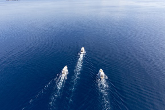 3 ships racing across a blue sea