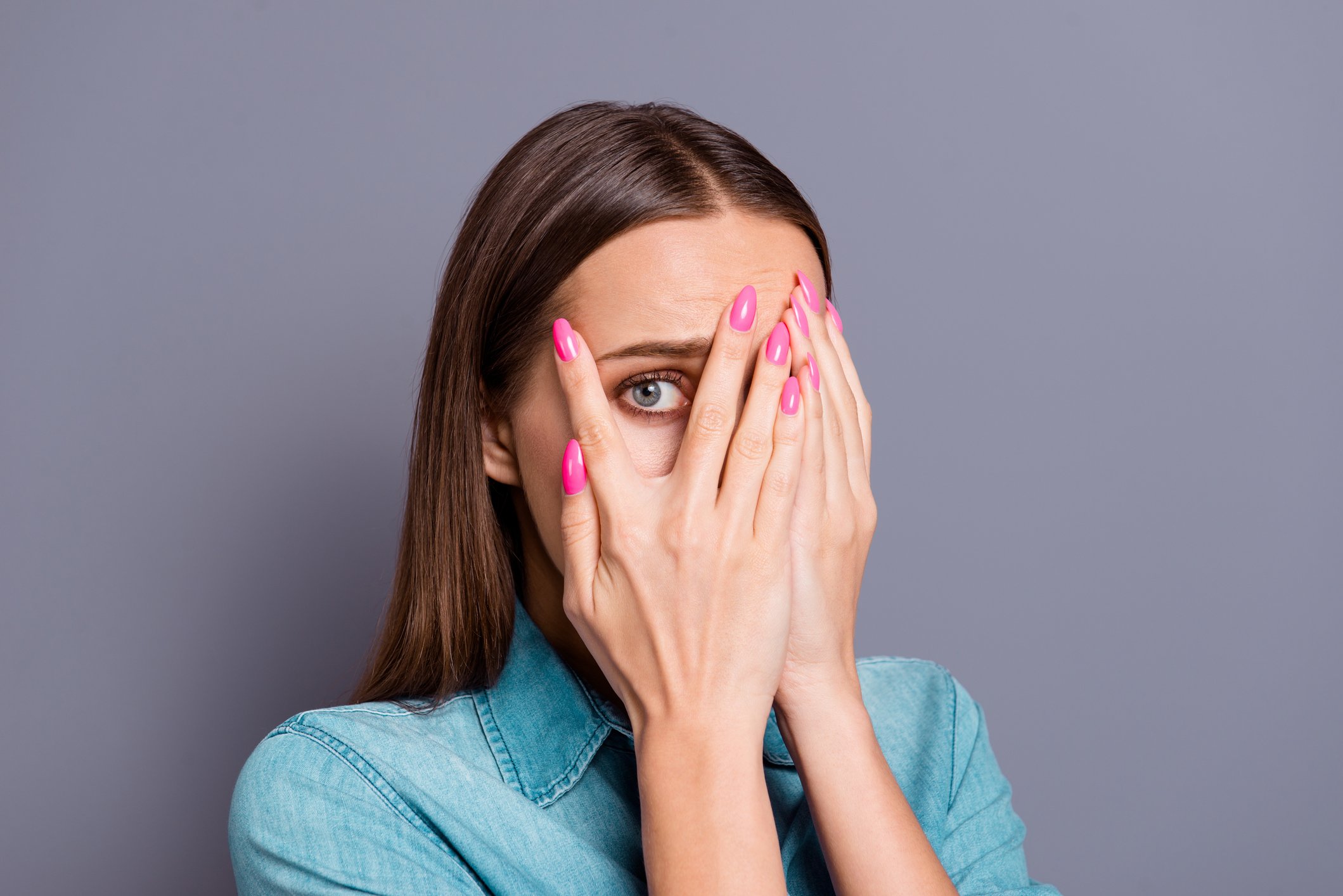 Woman with hands over face 