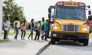 kids getting on school bus