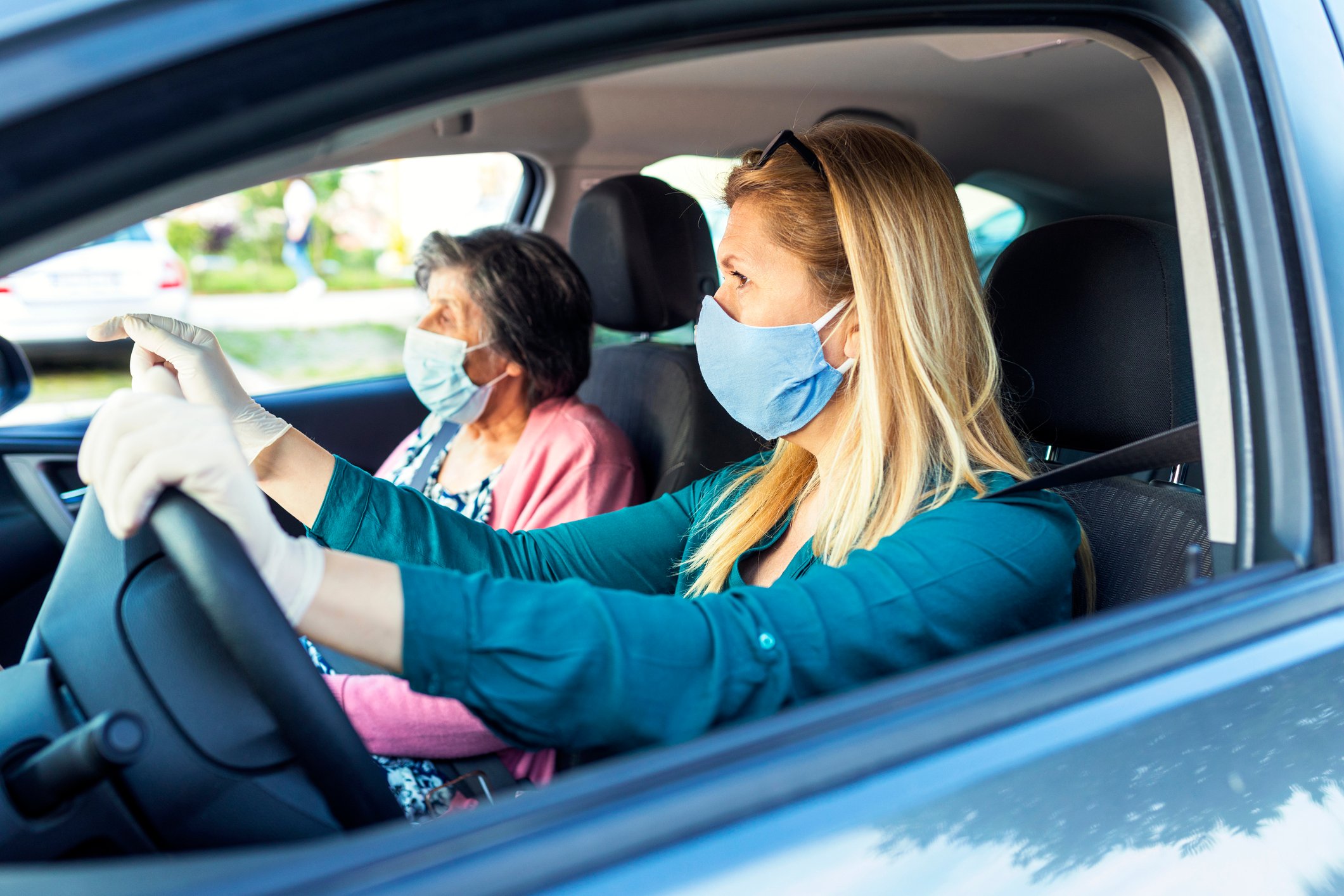 Senior citizen in vehicle with driver.