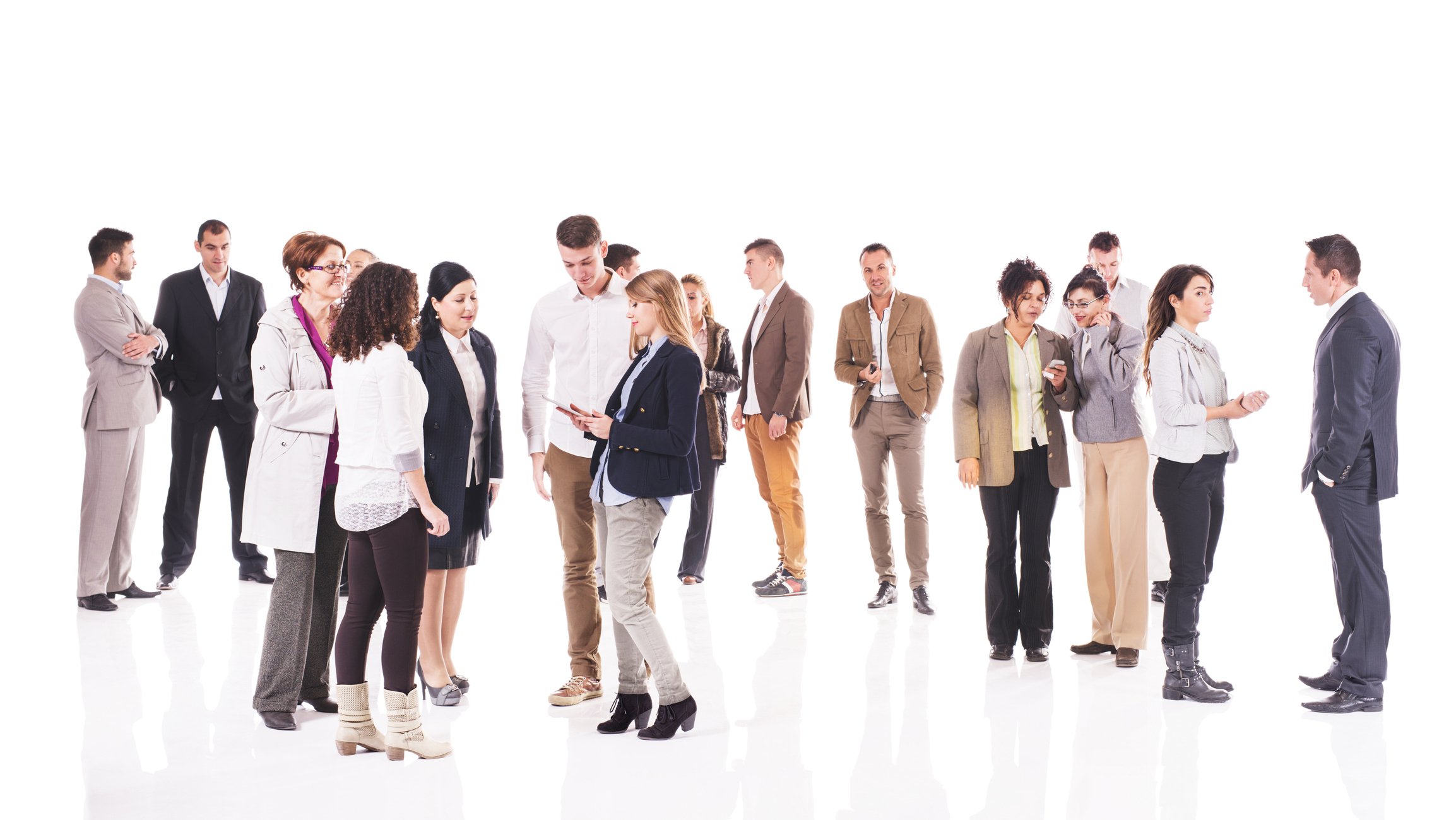 A standing crowd of people talking to one another.