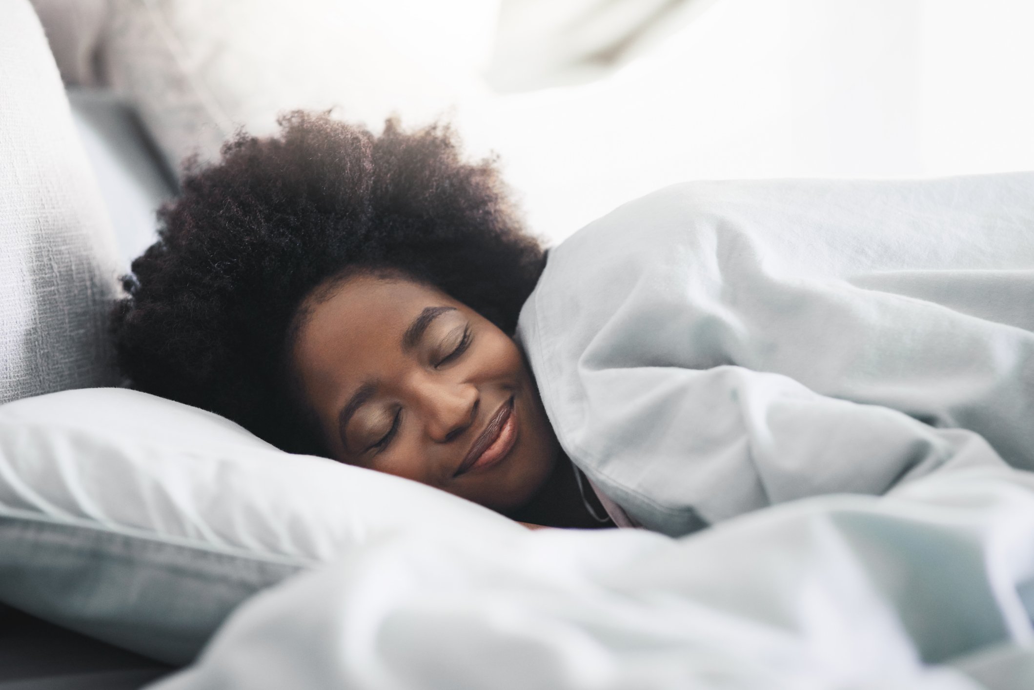 GettyImages-woman sleeping with a smile