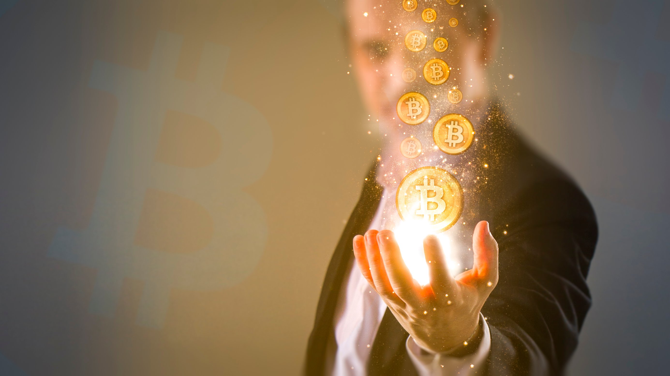 A man holding virtual Bitcoin tokens 