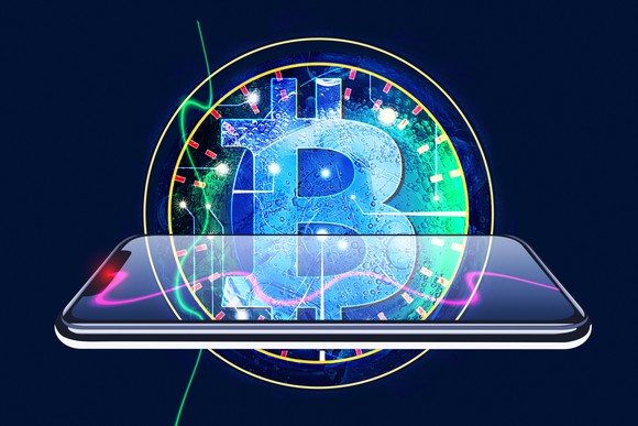 The Bitcoin emblem superimposed over the image of a smartphone.