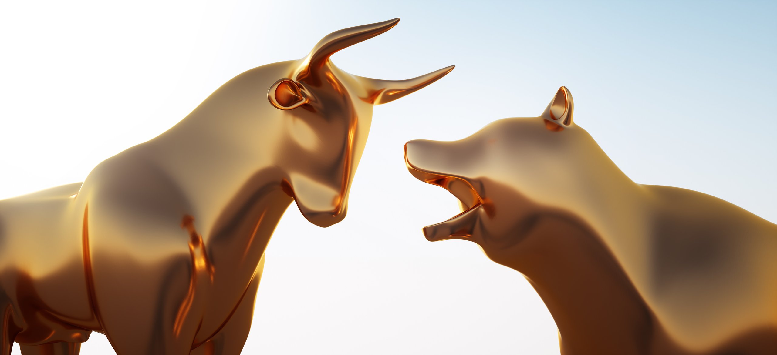 Golden bull and bear statues facing each other.