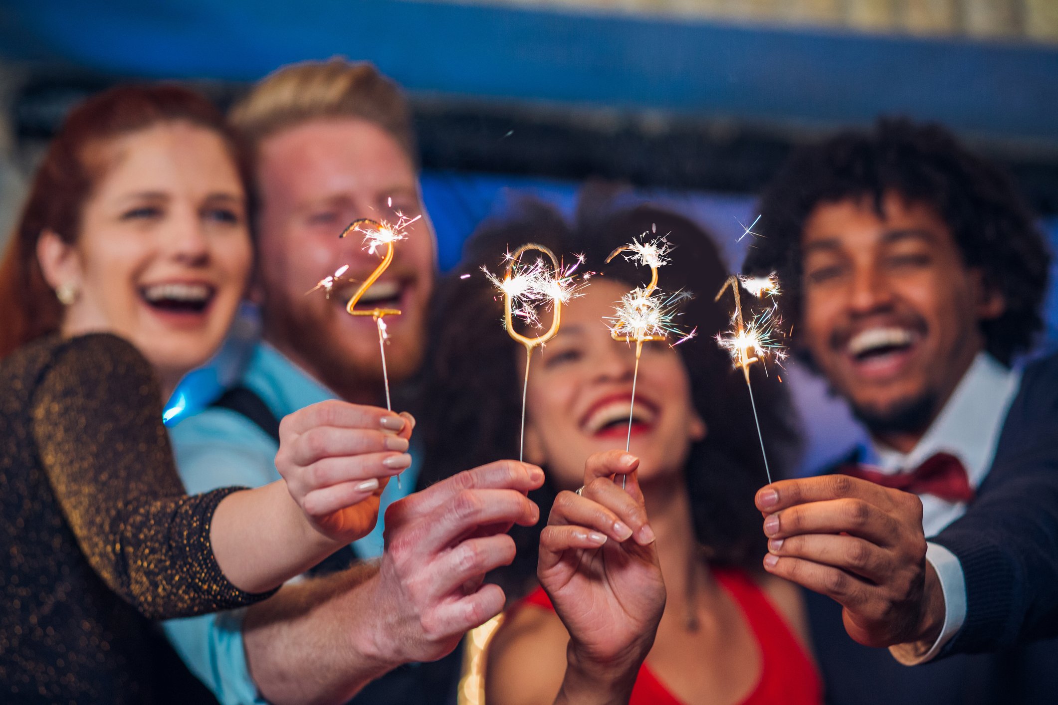 Two couples hold up sparklers to celebrate the start of 2021.