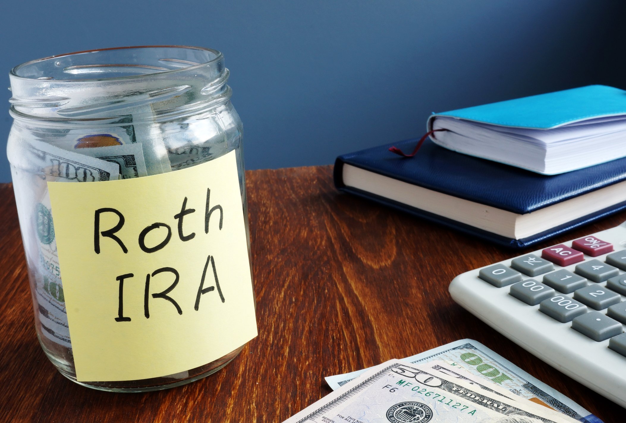 A jar full of money with a note labeled Roth IRA.