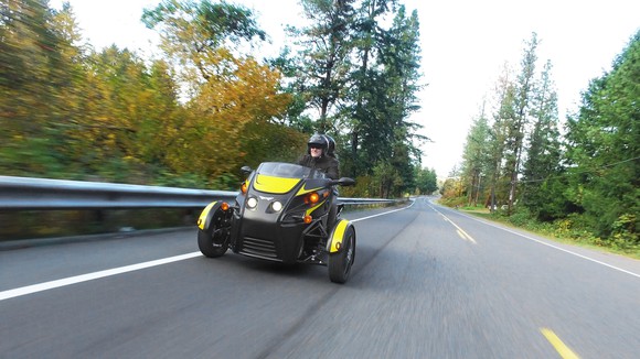 Two people riding in an Arcimoto Roadster.