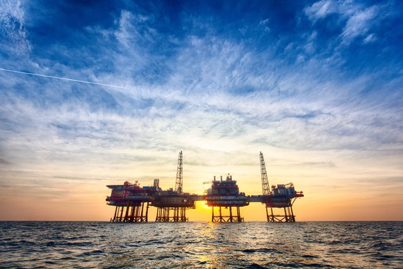 Offshore oil platform at sunset. 