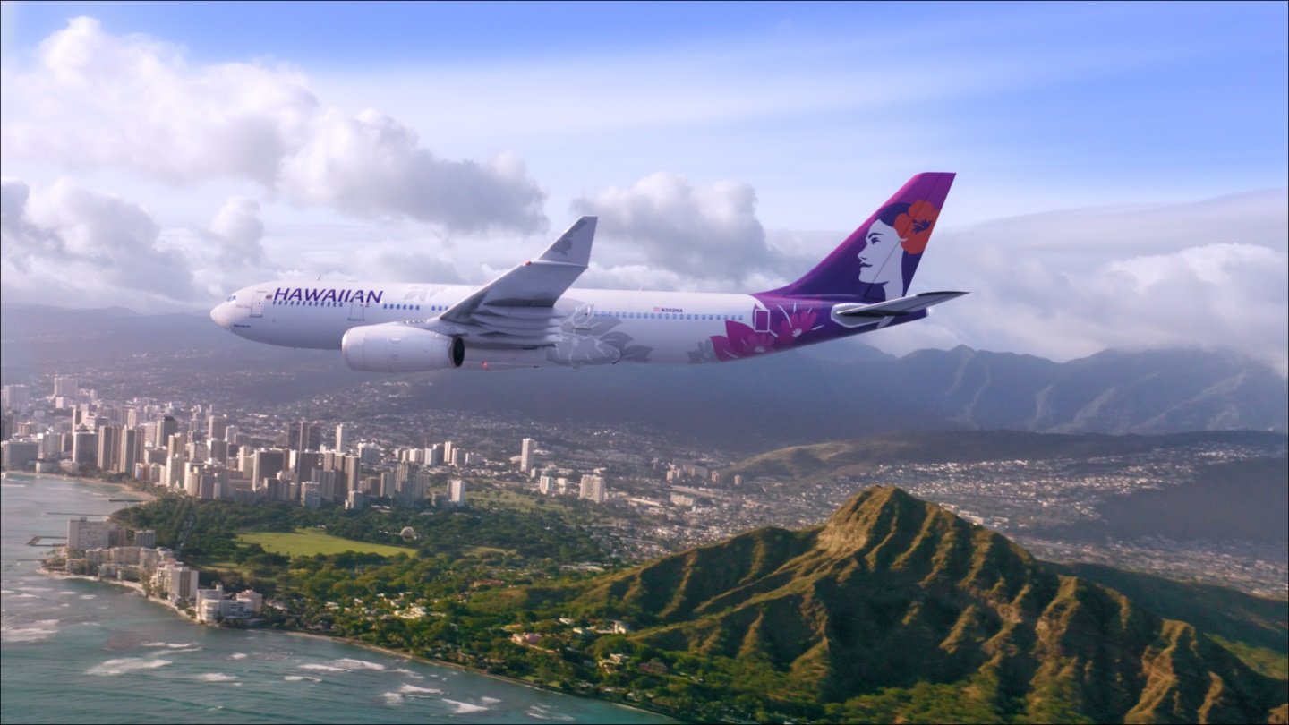 A Hawaiian plane flies over Diamond Head.