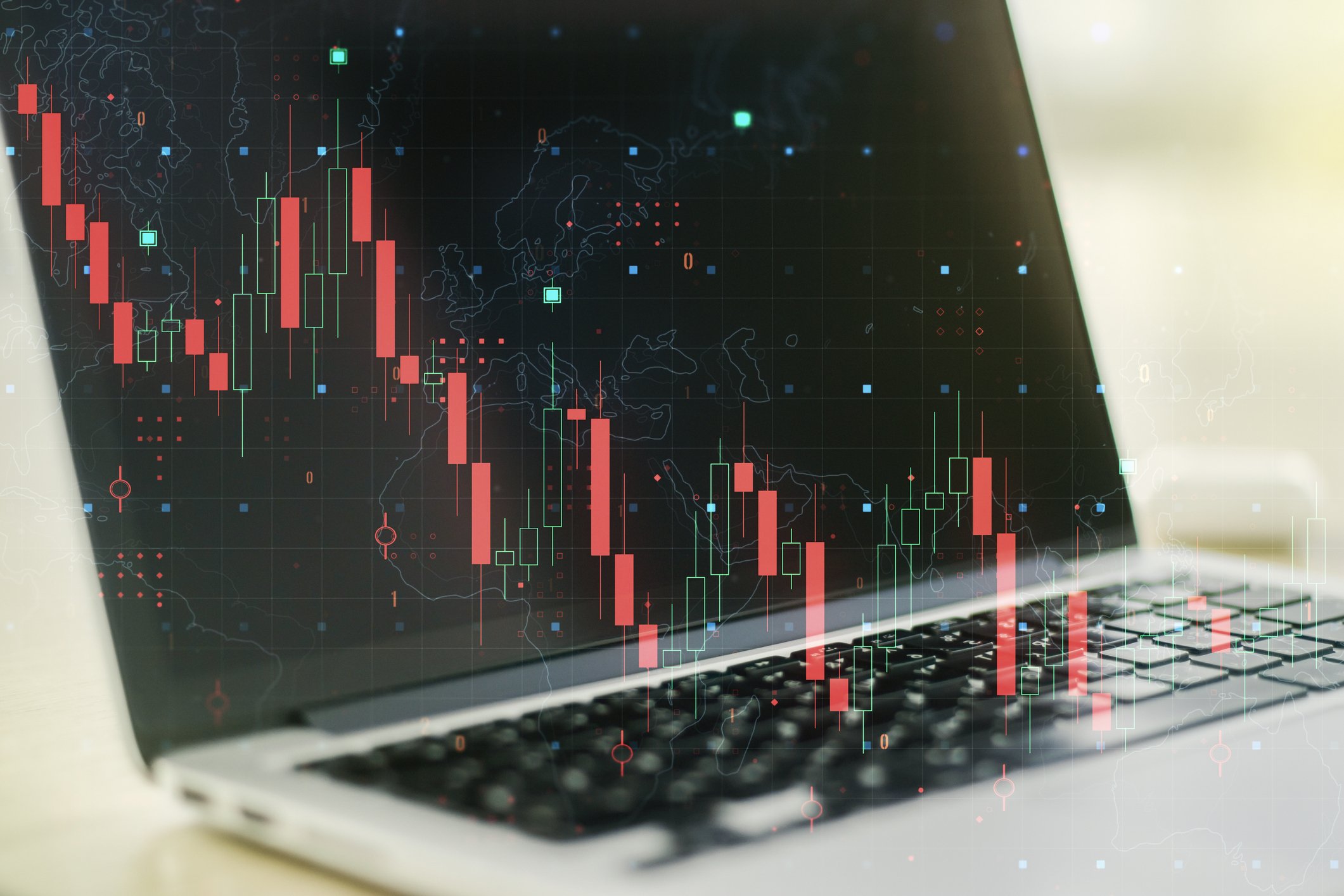 A red graph made of vertical bars superimposed over an open laptop.