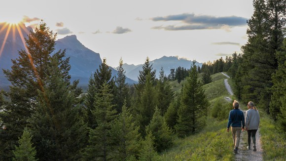 Senior couple walking on mountain trail 