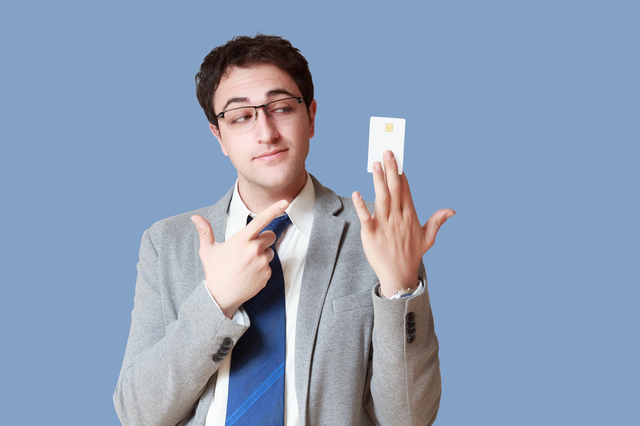 Man holding up credit card and pointing at it 
