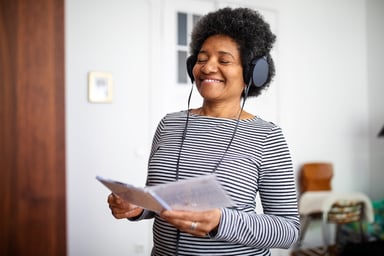 Woman listening to headphones standing up