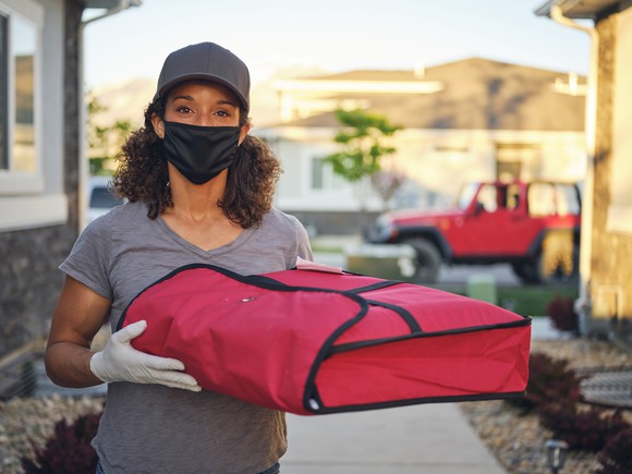 A person with a food delivery bag.